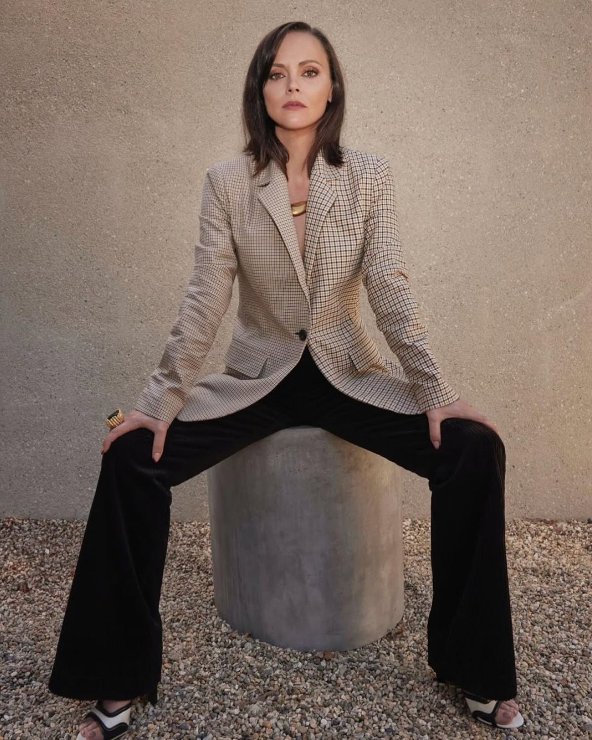 Christina Ricci photographed in a checked blazer and wide black trousers